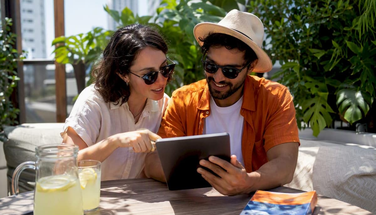 Travelers using tablet to select eSIM plans outdoors