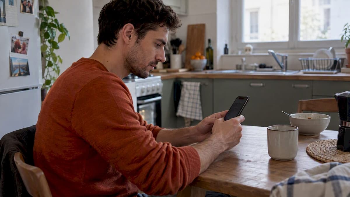 Traveler checking phone settings in a rented flat