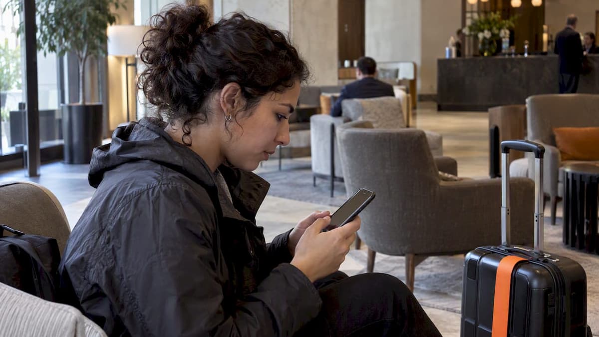 Traveler configuring iMessage on an iPhone abroad