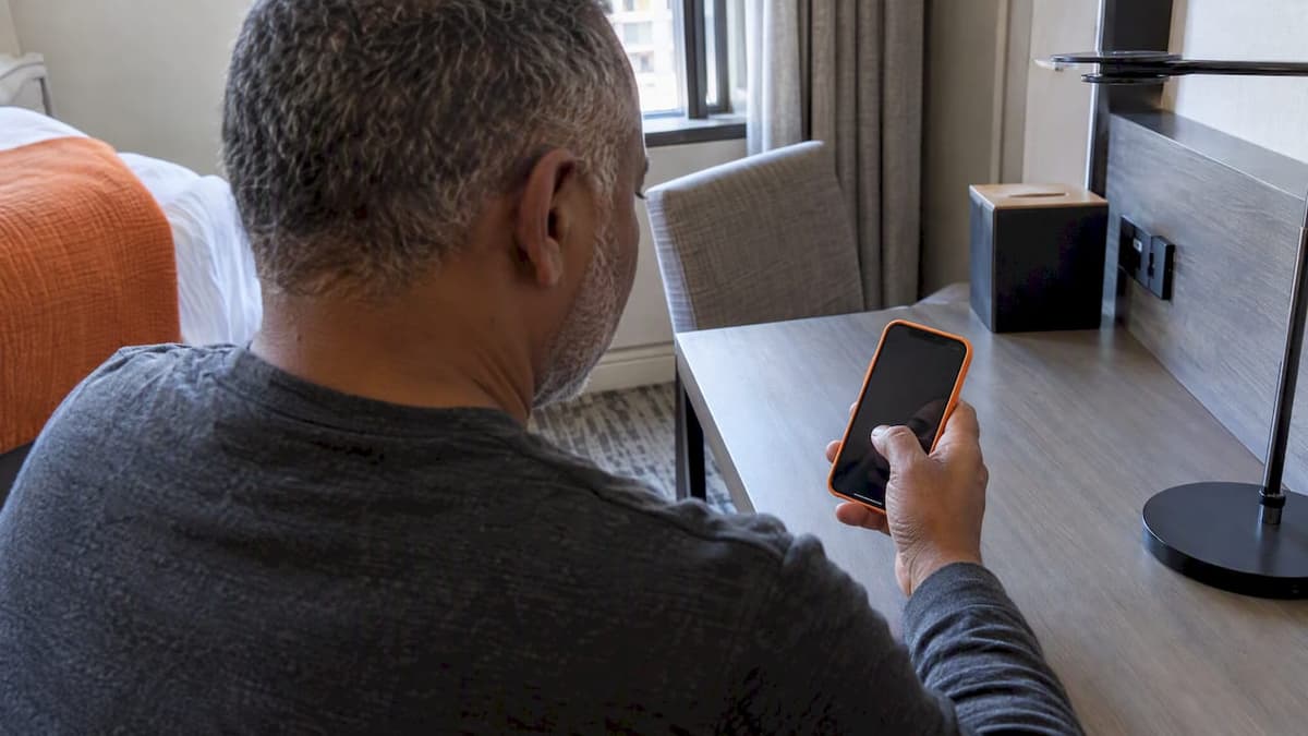 Traveler checking eSIM reset choice on iPhone